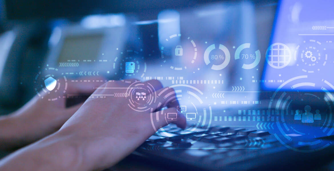 Hands typing on a keyboard with virtual interface representing data analytics