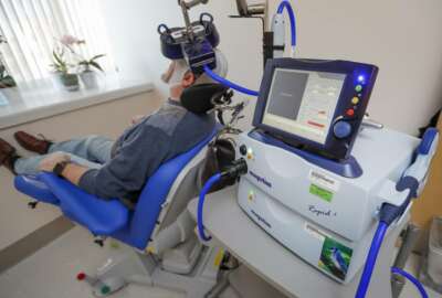 A patient receives a transcranial magnetic stimulation treatment at the VA Palo Alto Health Care System on Wednesday, Nov. 7, 2018, Palo Alto, Calif. The device, which uses magnetic fields to stimulate the brain, is being used on military veterans suffering from depression. (AP Photo/Tony Avelar)