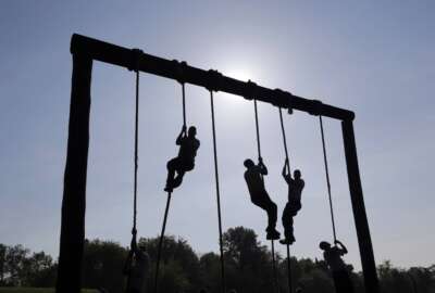 Freshman midshipmen, known as plebes, climb ropes on an obstacle course during Sea Trials, a day of physical and mental challenges that caps off the freshman year at the U.S. Naval Academy in Annapolis, Maryland.