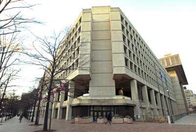 This Friday, Feb. 2, 2018 file photo shows the Federal Bureau of Investigation building in Washington. On Friday, June 18, 2021, The Associated Press reported on a video circulating online incorrectly asserting the FBI headquarters building in Washington is completely closed, empty and walled off. A video spreading the false claim shows the back of the building rather than the main entrance, which was open and fully operational this week, according to a statement from the FBI and the observations of an AP reporter based nearby. (AP Photo/Jose Luis Magana, File)