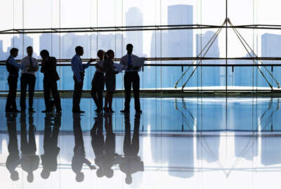 silhouettes of workers in an office