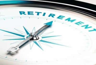 Compass with needle pointing the word retirement, concept image to illustrate retirement planning